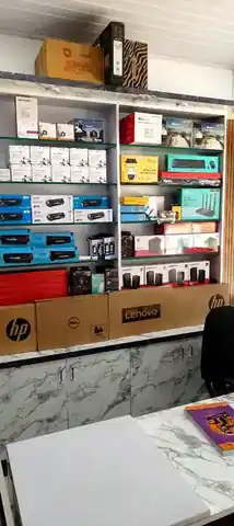 Real Ultimate Computers interior with shelves of computer accessories, printer supplies and branded laptop cartons in Kumta